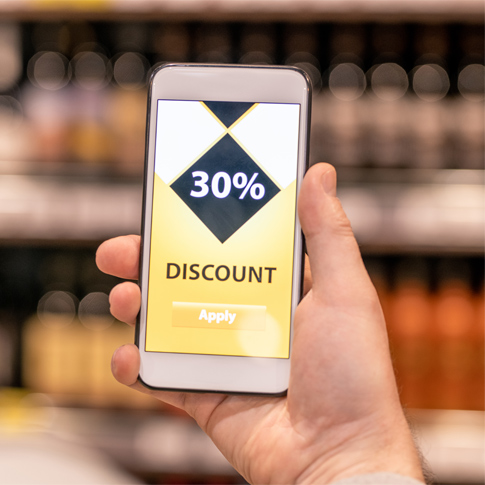 A person holding a mobile phone with 30% discount on it