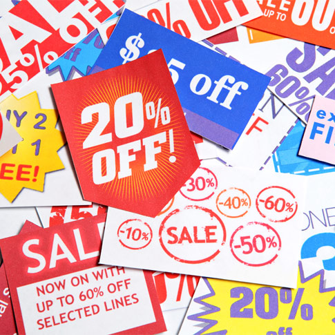 A pile of sale tags lying on a white background with 20% off on it