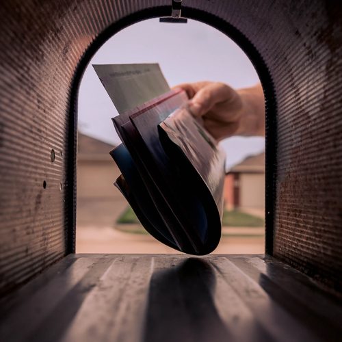 A man takes a document from the mailbox